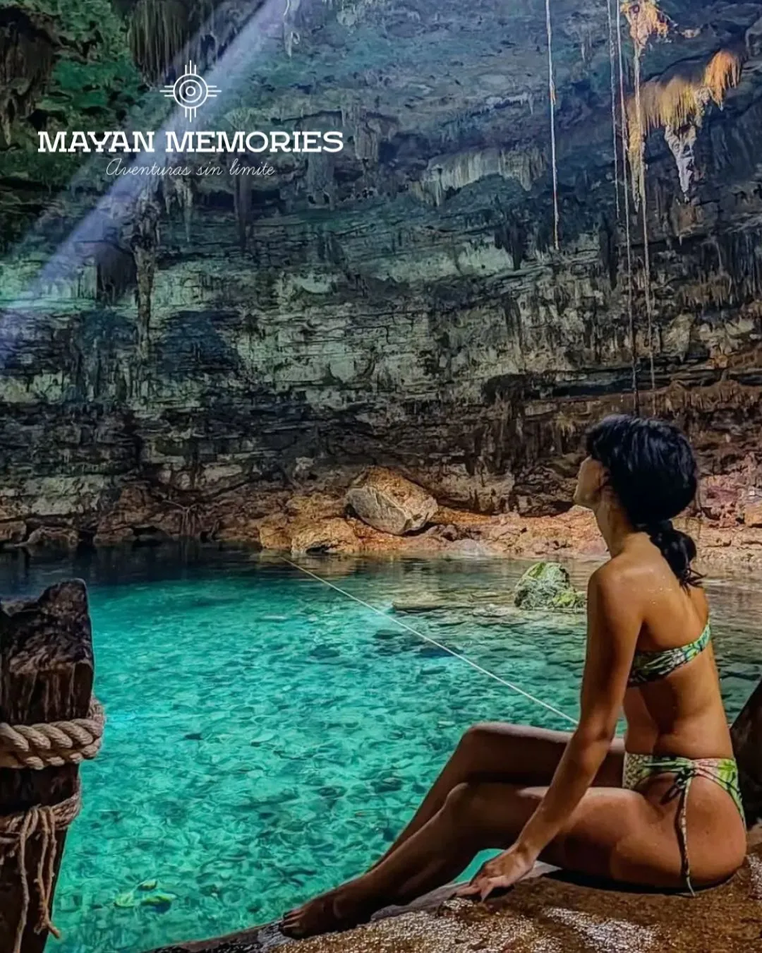 Woman gazing at the turquoise water of a cave cenote