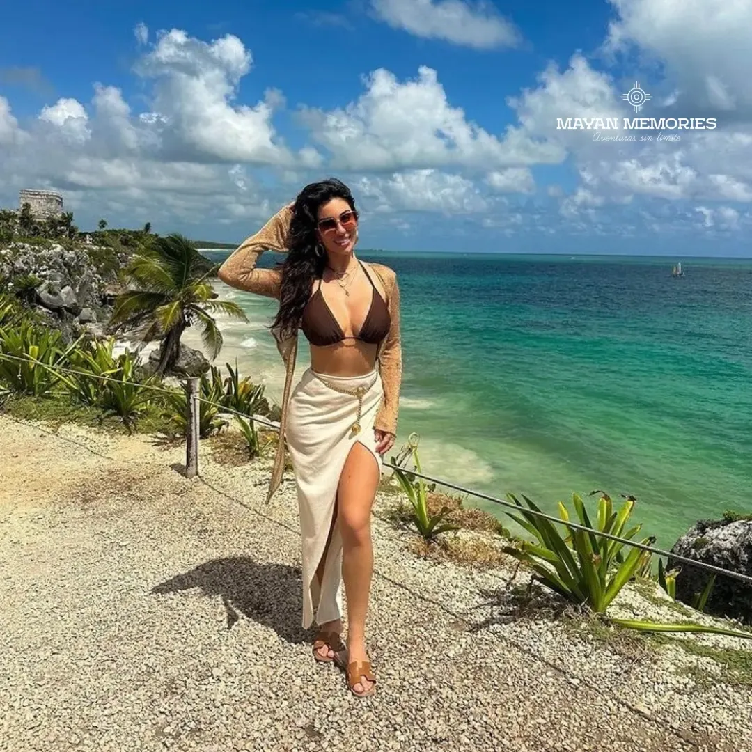 Woman in a bikini on the Tulum cliff above the sea