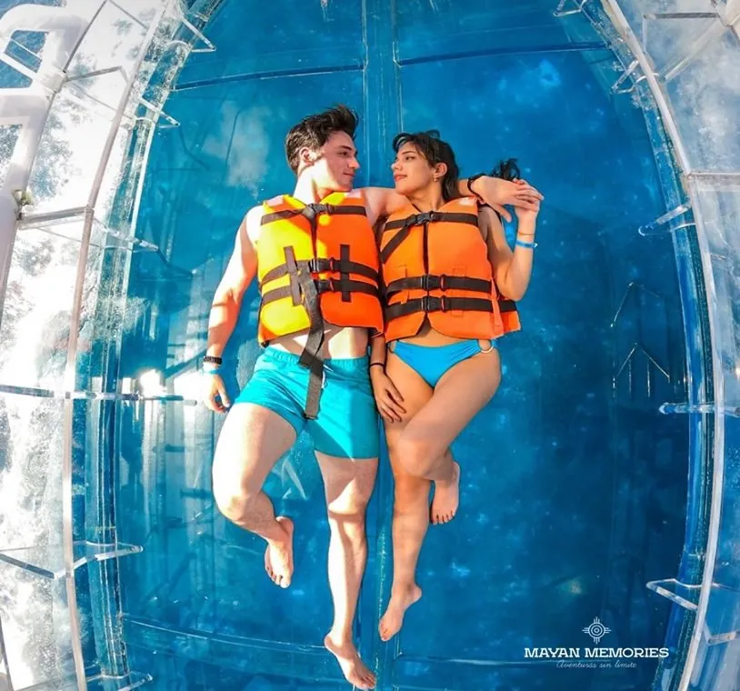 Couple in life jackets on board the clear boat