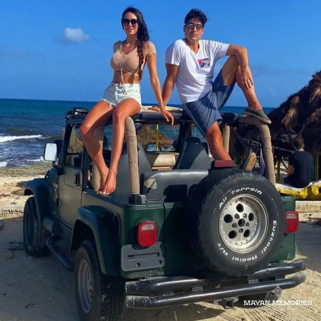 Dos personas sentadas sobre un jeep con llanta de refacción