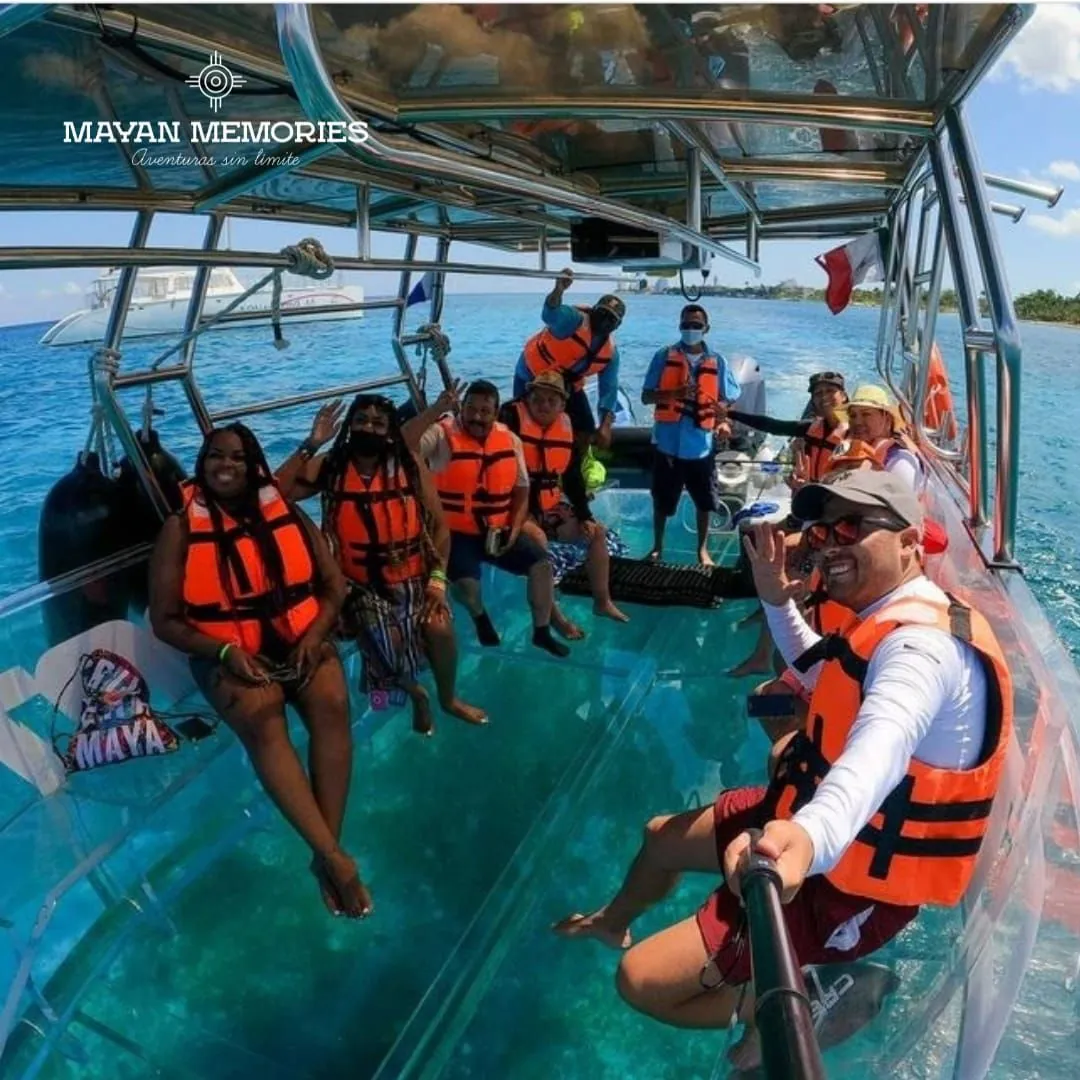 Passengers in orange life jackets on the clear-bottom boat
