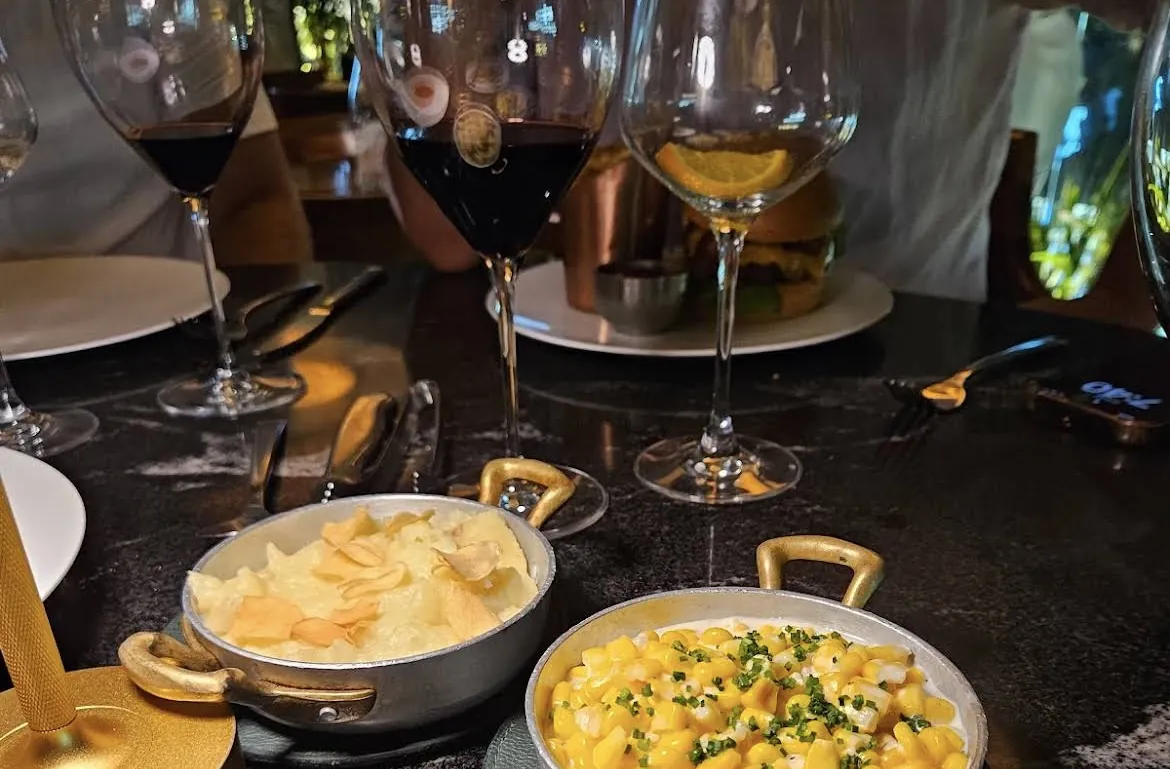 Dishes in skillets and wine glasses on the table