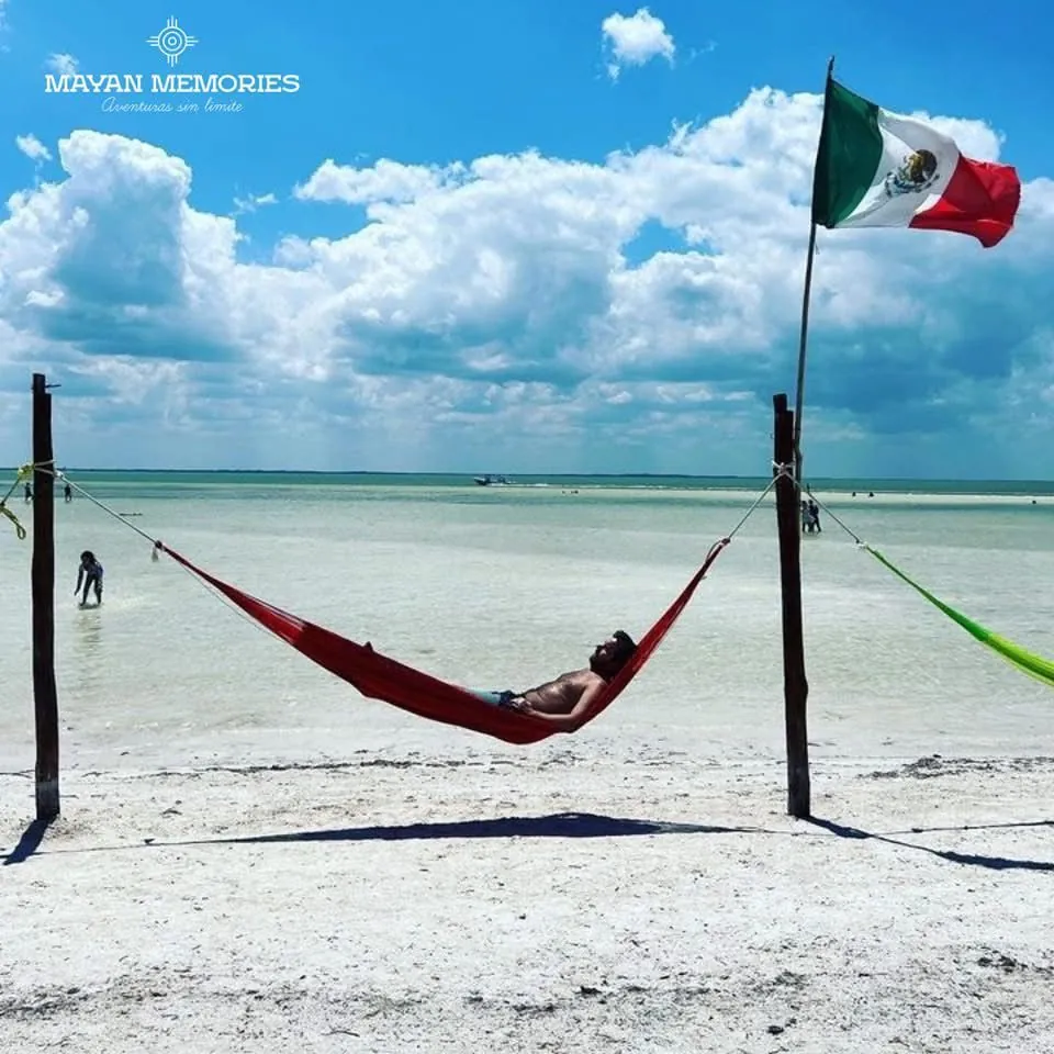 Hammock over shallow water on a white-sand beach in Holbox