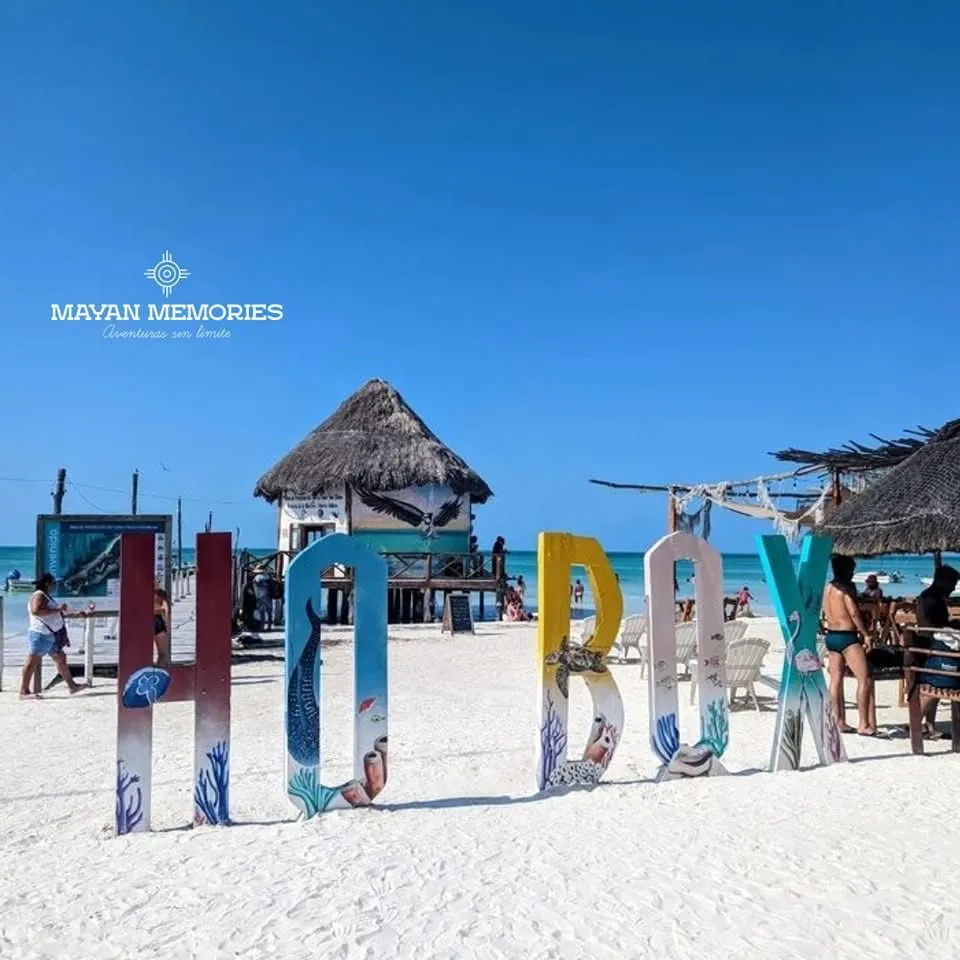 Woman among the colorful Holbox letters on the beach