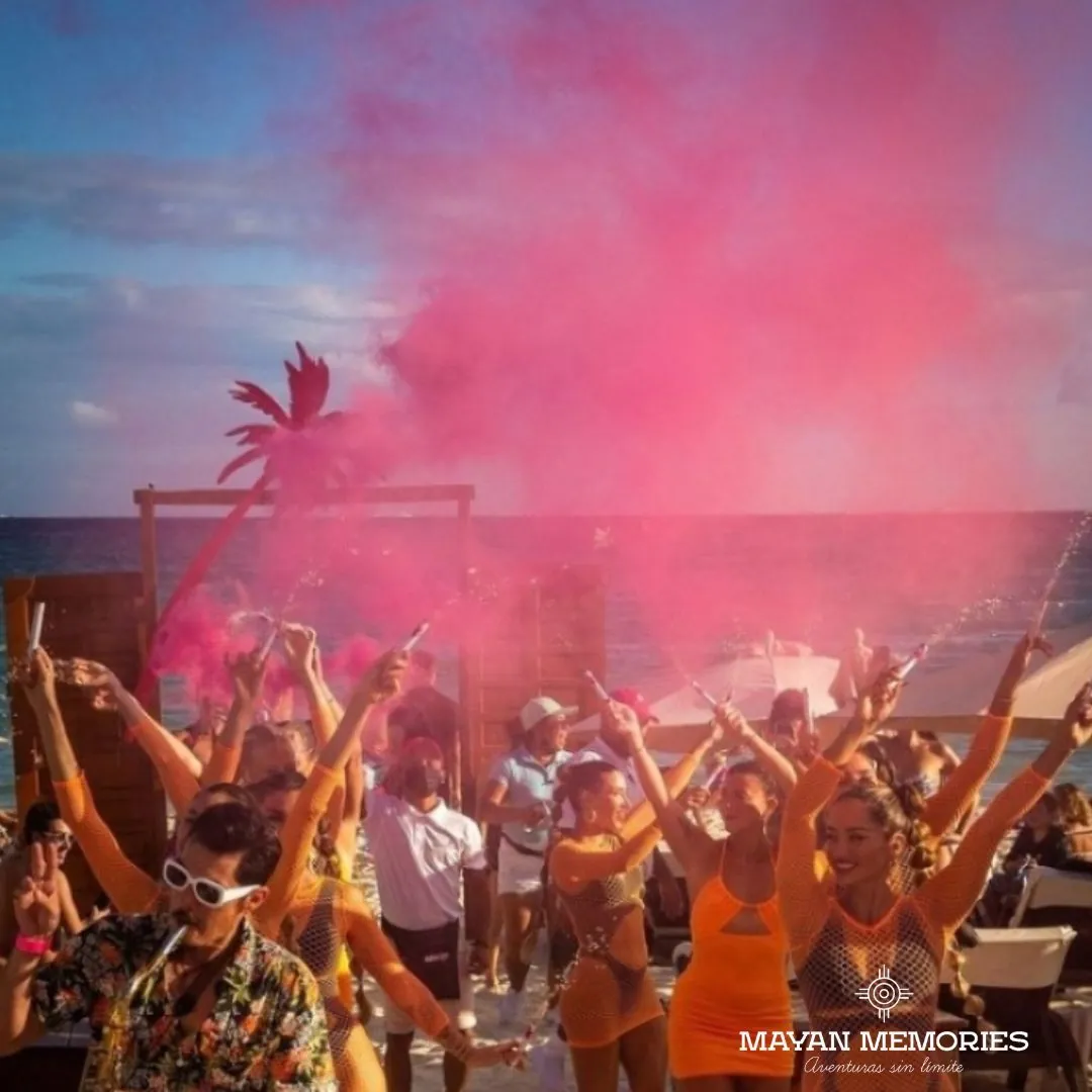 Party at the beach club with pink smoke