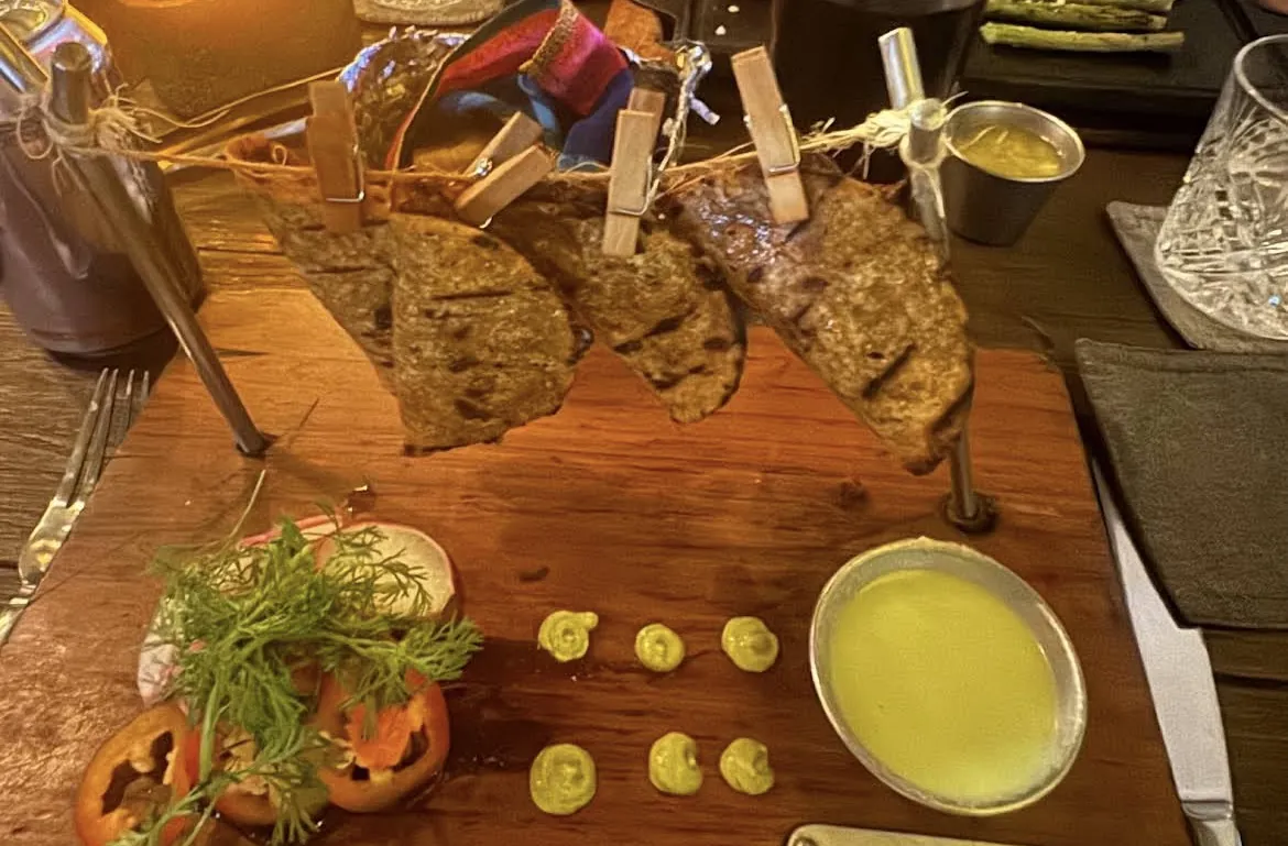 Tacos and salsas served on a wooden board