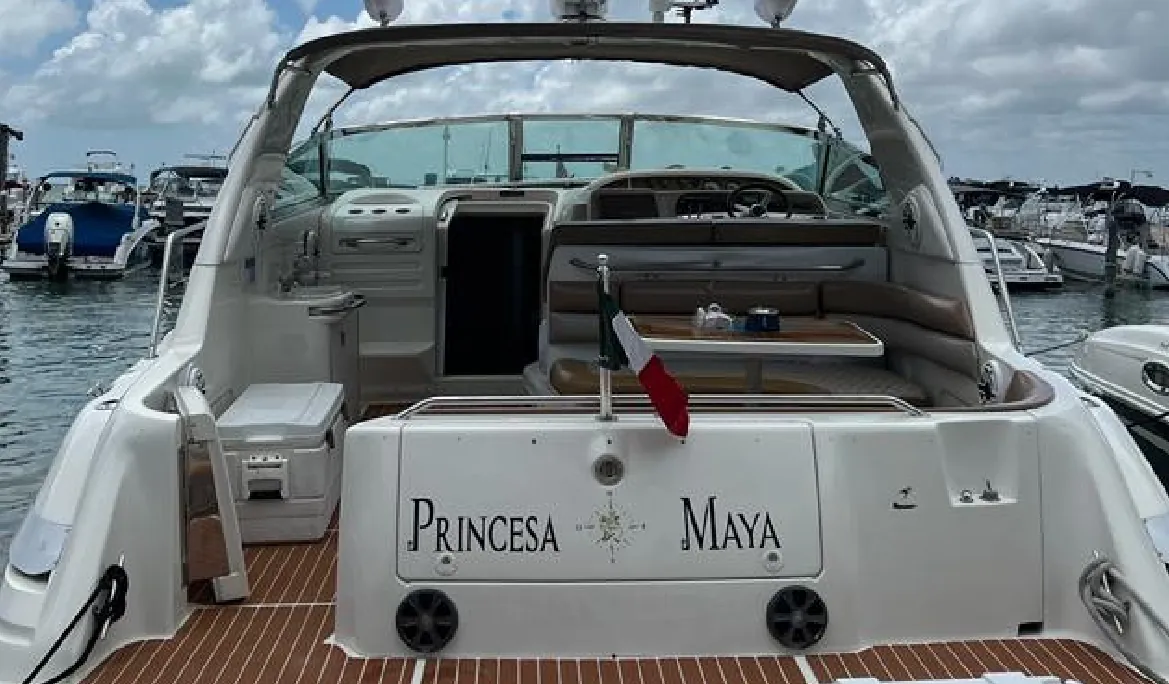 Stern of the Princesa Maya yacht with its name at the marina