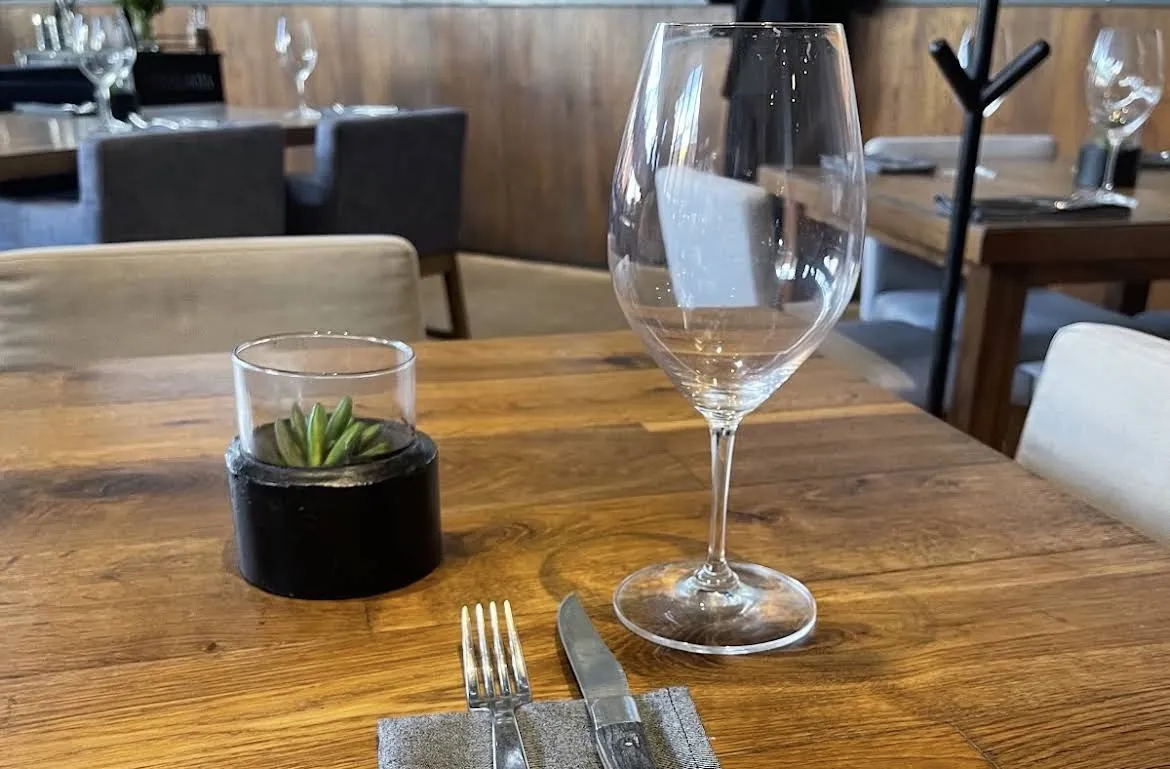 Table with a wine glass and a succulent at Sonora Prime