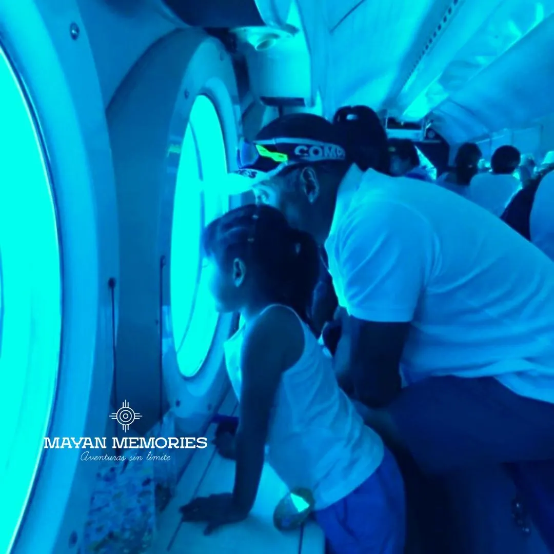 Girl and adult watching fish through the submarine porthole