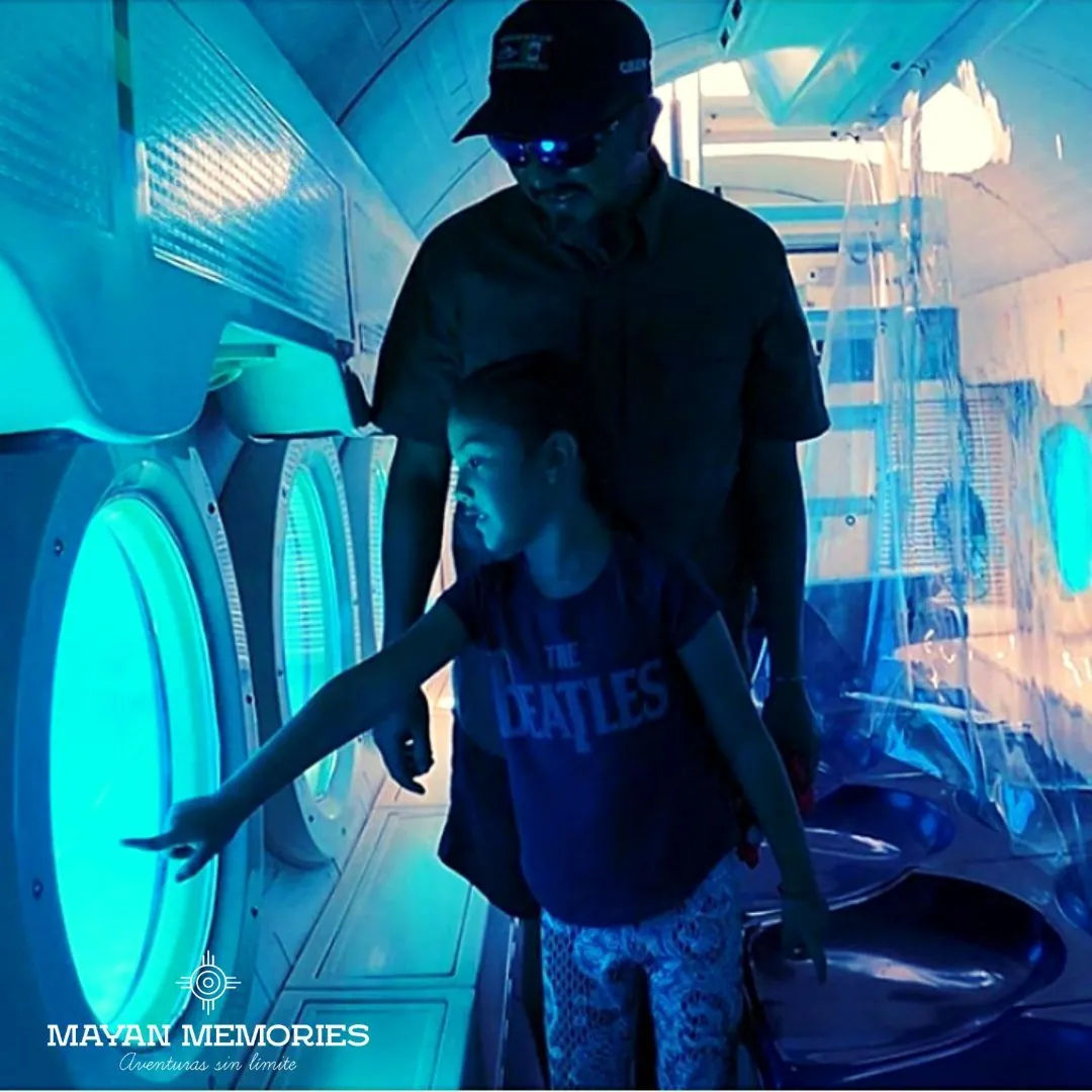 Boy pointing at the lit porthole inside the submarine