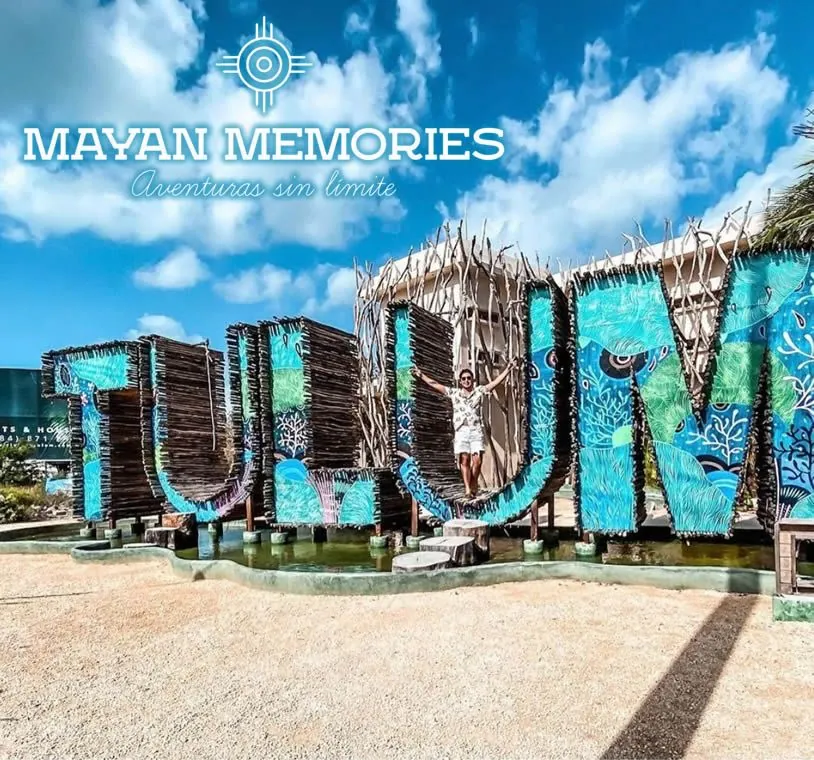 Blue Tulum letters surrounded by jungle