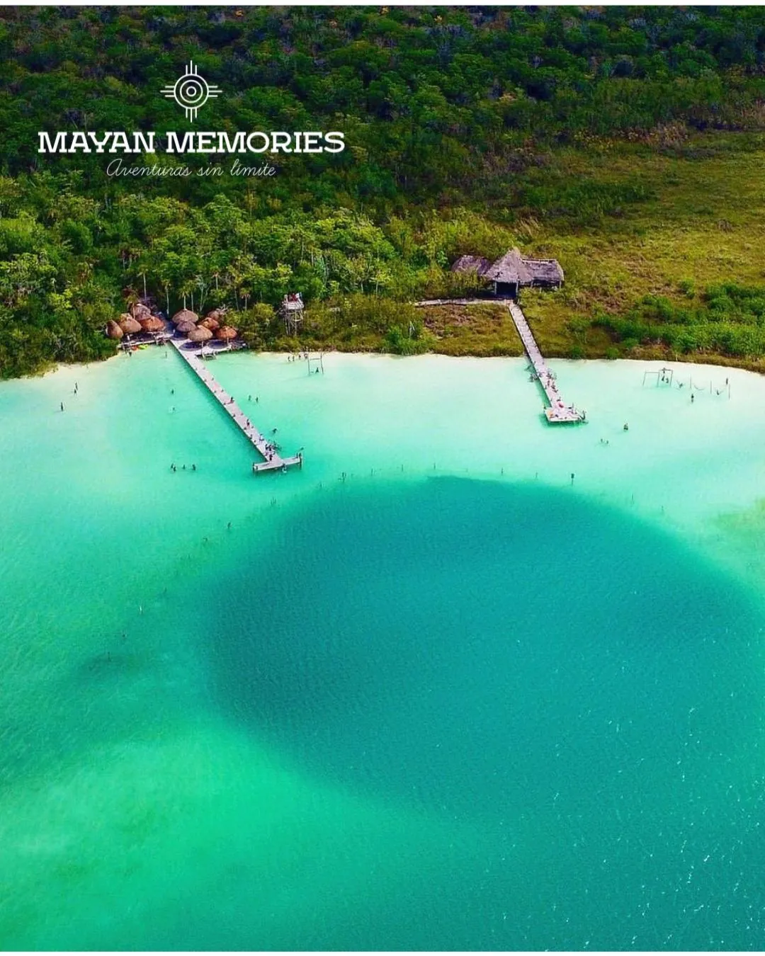 Aerial view of a turquoise lagoon with wooden piers