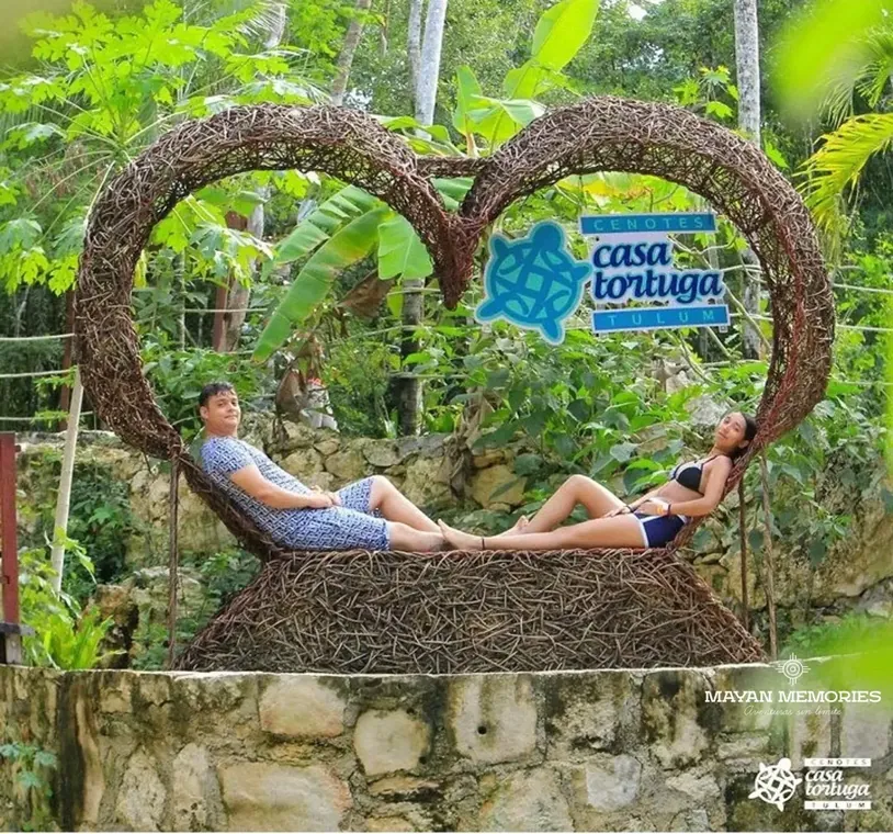 Couple lying in a heart-shaped wooden frame at Casa Tortuga