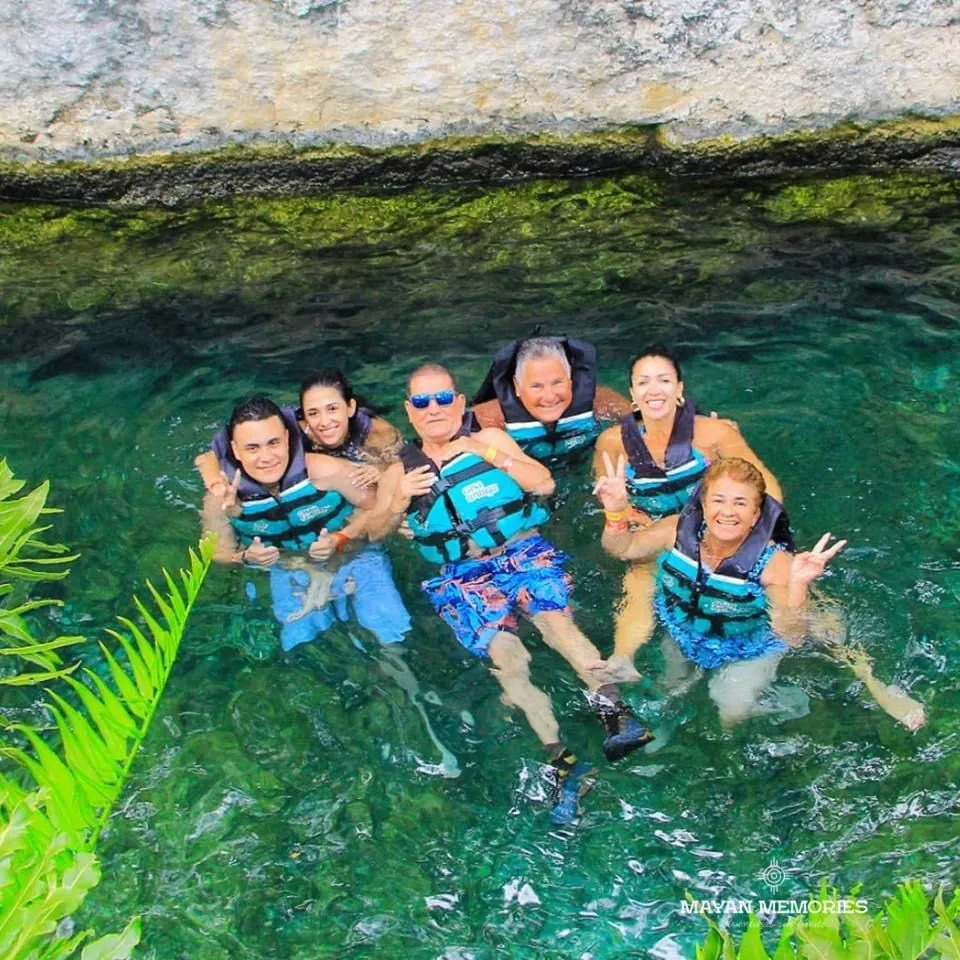 Group in life jackets swimming in a cenote
