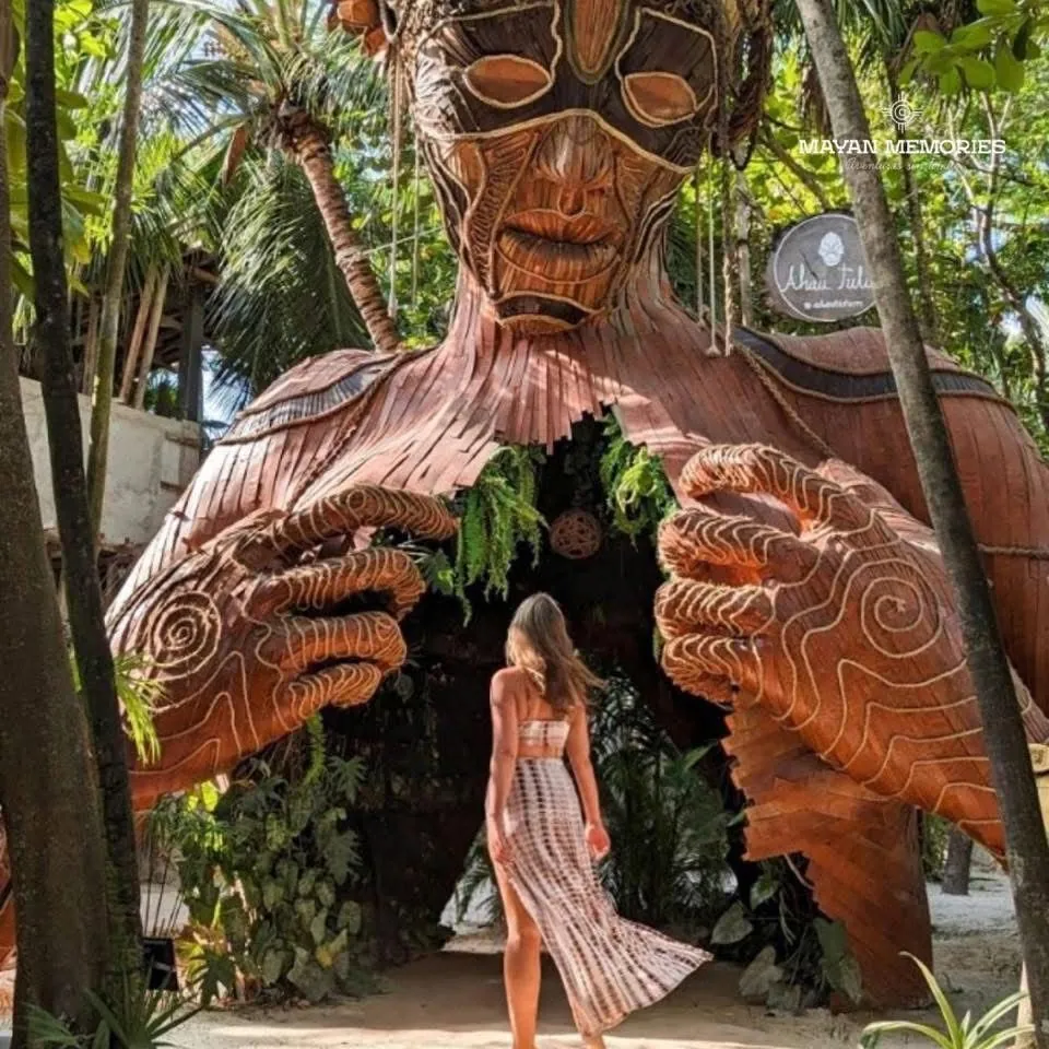 Visitante frente a la escultura de madera de la Madre Naturaleza
