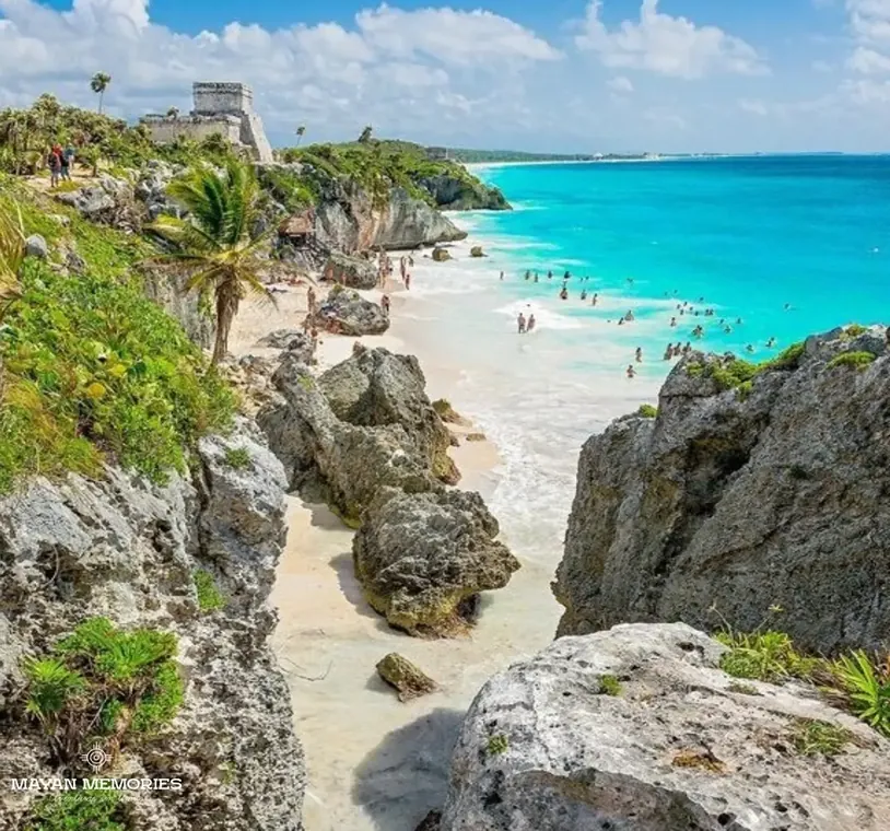White-sand cove between rocks beside the Tulum ruins