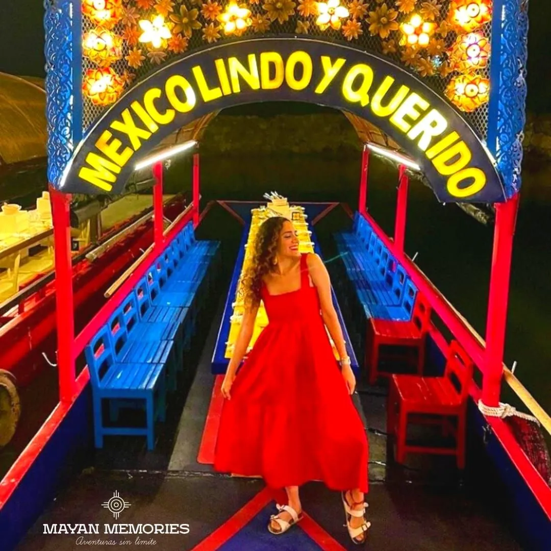 Woman in a red dress on a colorful trajinera
