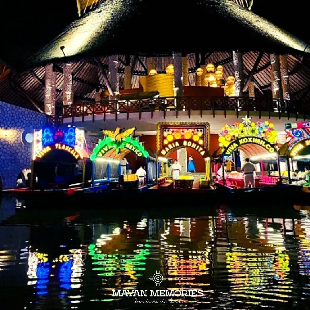 Colorful lit trajineras on the canal at night