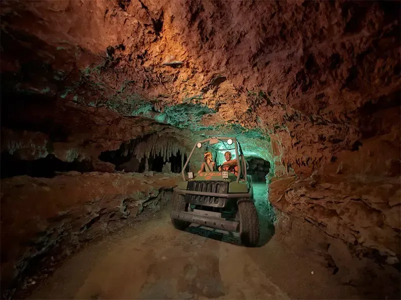 Amphibious vehicle driving through a rock tunnel